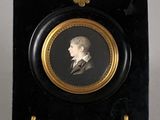 portrait of a man in a suit and tie in a black and gold frame