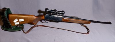 a rifle that is on display on a white background