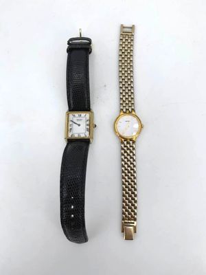 a couple of watches sitting next to each other on a table
