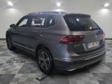the rear of a silver volkswagen suv parked in a garage