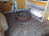 a tire that is sitting in the back of a van