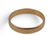 a close up of a gold ring on a white surface