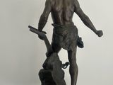 statue of a man with a gun and a dog on a pedestal