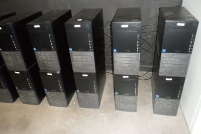a lot of computer equipment that are sitting on the floor