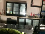 a kitchen with a black counter top and a black refrigerator