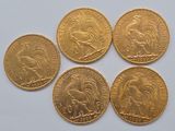 four gold coins with a picture of a horse and a lion on them