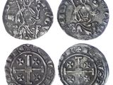 four silver coins with a cross and a cross on them