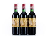 three bottles of red wine sitting next to each other on a white surface