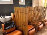 an image of a salon with chairs and a sink