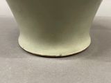 a close up of a white bowl on a table