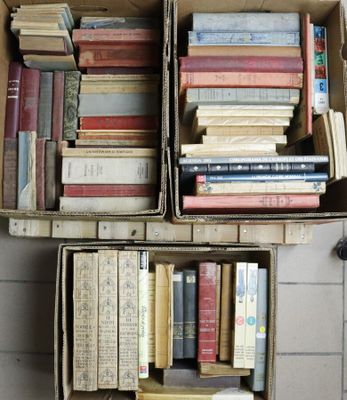 boxes of books are stacked on top of each other on a tiled floor