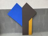 a blue, yellow and brown piece of art on the ground