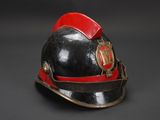 an old fireman ' s helmet on a black background