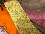 many different colored ties laid out on a wooden floor
