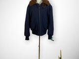 a mannequin with a hat and jacket on a stand
