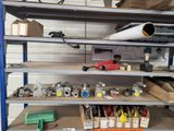 many different types of tools on the shelves in the garage