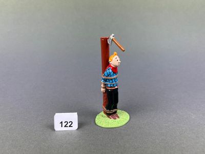 figurine of a man holding a baseball bat on a green base