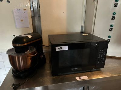 a black microwave sitting on top of a counter next to a mixer