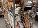 a large metal cage with a bunch of items inside of it