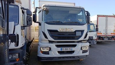 two trucks parked next to each other in a parking lot