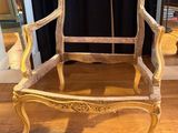 a wooden chair that is sitting on a hard wood floor