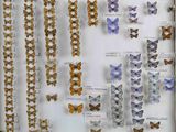 many different types of butterflies displayed in a display case