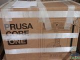 a cardboard box with a sign on it sitting on a pallet