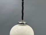 a close up of a white light hanging from a ceiling
