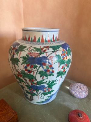 a vase that is sitting on a table next to a mouse
