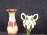 two vases that are sitting on a black surface