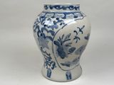 a blue and white vase sitting on a white surface