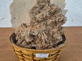 a small basket with a bunch of dried flowers in it