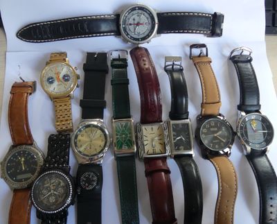 a lot of watches that are sitting on a table