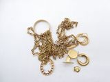 a lot of gold jewelry on a white surface