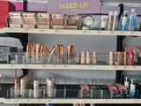 a lot of makeup products on the shelves in the store