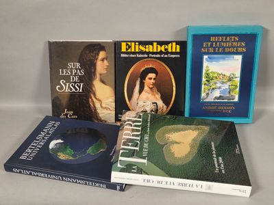 several books are sitting on a table with a white background