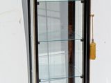 a display case with a glass door on the wall