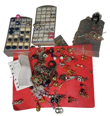 a red table with a bunch of jewelry on it