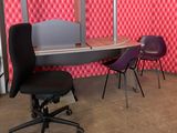 a desk with two chairs and a computer on it