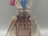 a glass bell with a blue and pink decoration on it