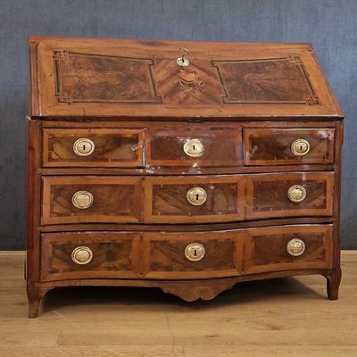 a small wooden desk with drawers on top of it