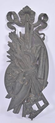 a metal sculpture of a woman with a bird on her head