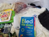a bag of food and a book sitting on a bed