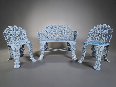 three chairs and a table in a room