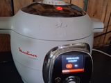 a white and black rice cooker sitting on a counter