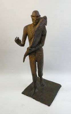 bronze statue of a man holding a bird on his shoulder