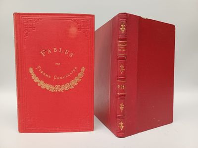 two red books sitting next to each other on a white surface