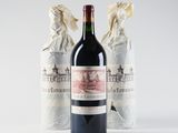 two bottles of wine sitting next to each other on a white surface