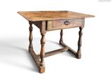 une vieille table en bois surmontée d'un tiroir