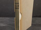 an old book sitting on top of a table next to a black background